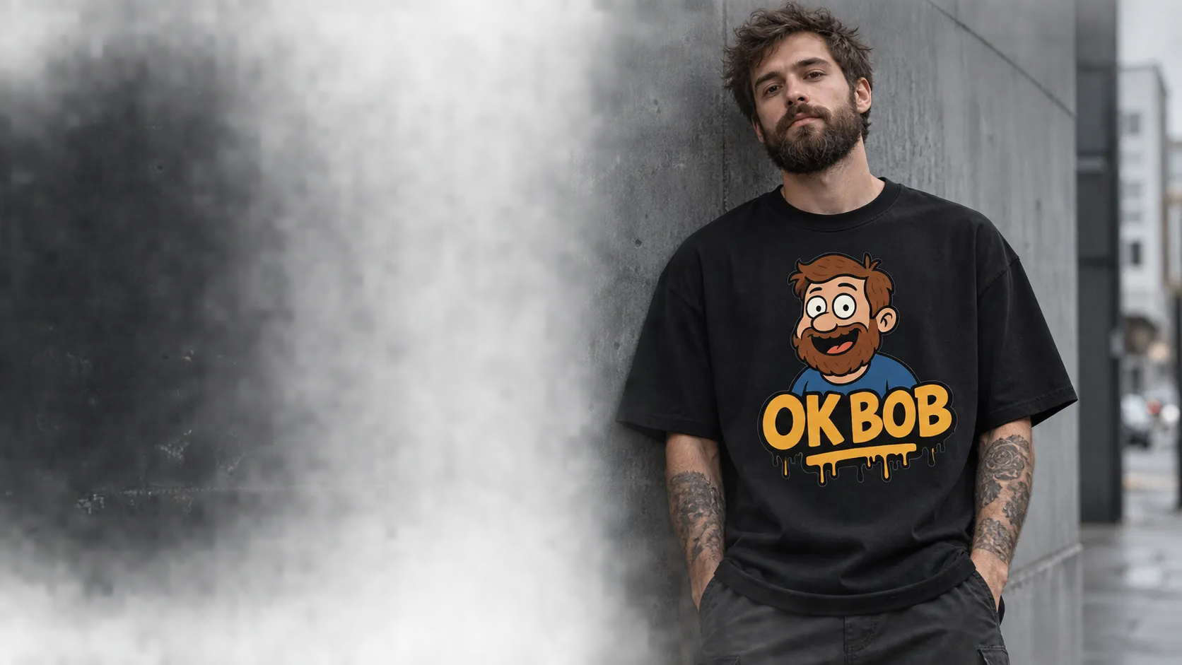 A model wearing a black Bob T-shirt, leaning against a concrete wall